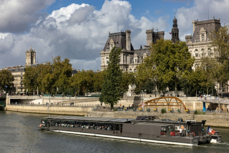 Un bateau mouche qui navigue sur la Seine, passe devant l'Hôtel de Ville de Paris, le 5 octobre 2025 ( AFP / JOEL SAGET )