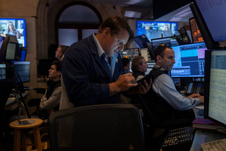Traders work on the floor at the New York Stock Exchange (NYSE) in New York City