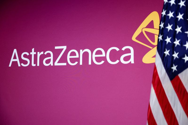 Un drapeau américain est planté à côté du logo d"AstraZeneca à Washington, D.C.