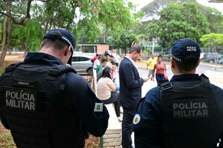 Des membres de la police militaire gardent l'entrée d'un bureau de vote lors du premier tour de la présidentielle au Brésil, le 4 octobre 2026 à Brasilia ( AFP / Evaristo SA )