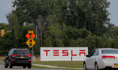 Cars pass by the Tesla Inc. Gigafactory 2, which is also known as RiverBend, a joint venture with Panasonic to produce solar panels and roof tiles in Buffalo, New York