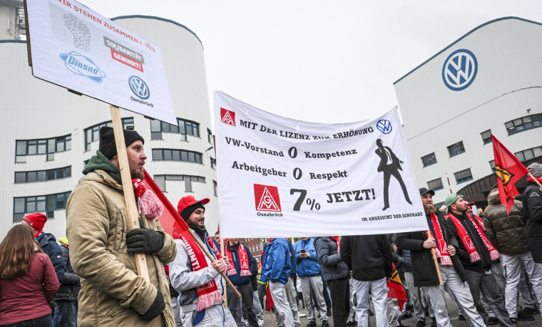 Des syndicalistes d'IG Metall manifestent devant l'usine du constructeur automobile Volkswagen lors d'une grève d'avertissement contre les mesures de réduction des coûts à Osnabruck, en Allemagne, le 6 novembre 2024. (crédit : Focke Strangmann / AFP)