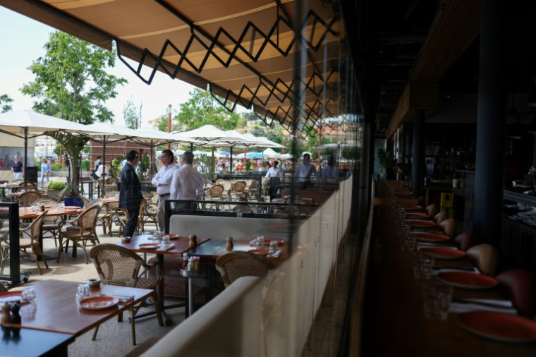 Restaurant personnel stand amid empty tables as after a power outage struck Southwestern France, on the final day of the 78th edition of the Cannes Film Festival in Cannes, southern France, on May 24, 2025. A major power outage hit the area around the French Rivera resort of Cannes on May 24, the final day of the city's film festival, though organisers said the closing ceremony would not be affected. The cause of the power cut, which began just after 10:00 am (0800 GMT), was a fire in a substation in the nearby village of Tanneron, probably an arson attack, police sources told AFP, asking not to be named.Grid operator RTE said 160,000 homes had been affected in Cannes and the surrounding area. The festival said it had "switched to an alternative electricity power supply, which enables us to maintain the events and screenings planned for today in normal conditions, including the closing ceremony". ( AFP / Sameer AL-DOUMY )