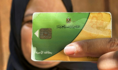 Une femme tient sa carte d'aide alimentaire, utilisée pour acheter des denrées alimentaires, au Caire, le 17 août 2026 ( AFP / Khaled DESOUKI )