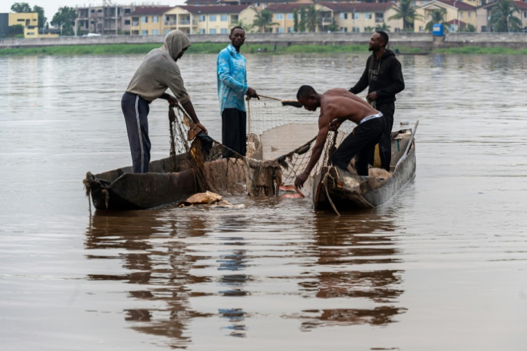 Des pêcheurs récupèrent des déchets plastiques pris dans l'un de leurs filets sur le fleuve Congo à Kinshasa, le 27 avril 2026 en RDC ( AFP / Hardy BOPE )