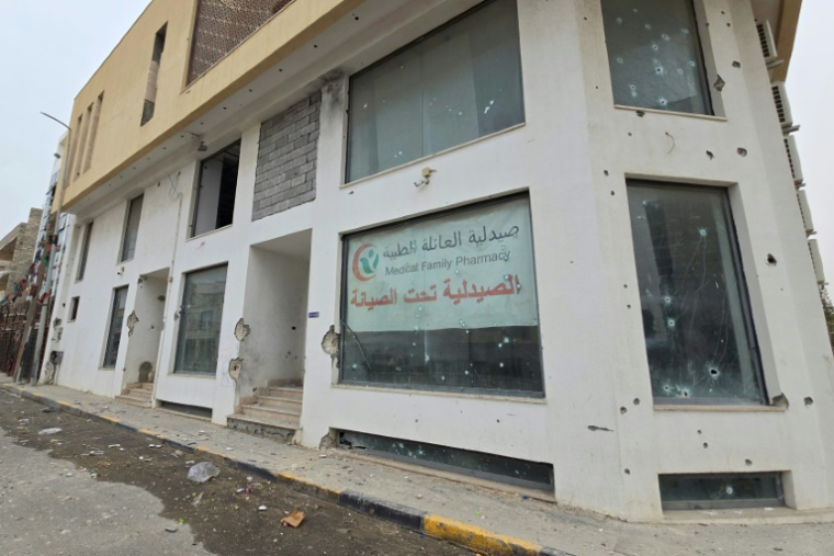 Un immeuble criblé d'impacts de balles à Tripoli, le 14 mai 2025 en Libye ( AFP / Mahmud Turkia )