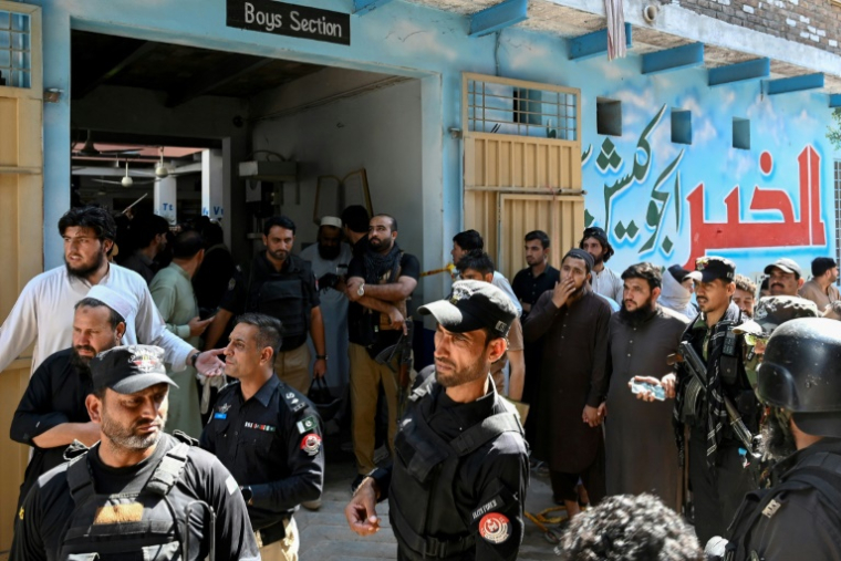 Des agents de sécurité montent la garde lors d’une opération de recherche après l’effondrement d’un toit dans une école à Peshawar, le 15 octobre 2026 ( AFP / Abdul MAJEED )