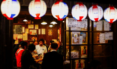 Des personnes boivent et mangent dans un pub izakaya dans le quartier commerçant d'Ameyoko, à Tokyo