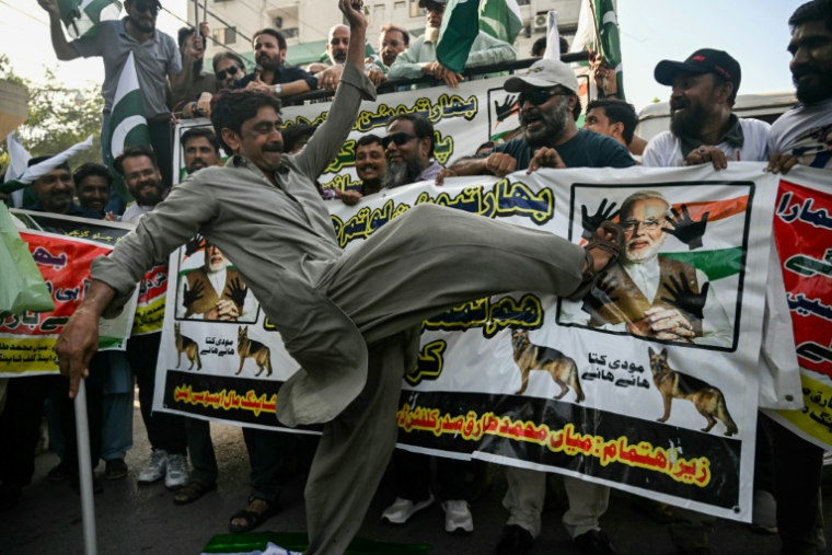 Un manifestant donne un coup de pied dans une affiche du Premier ministre indien Narendra Modi, le 29 avril 2025 à Karachi, au Pakistan ( AFP / Rizwan TABASSUM )