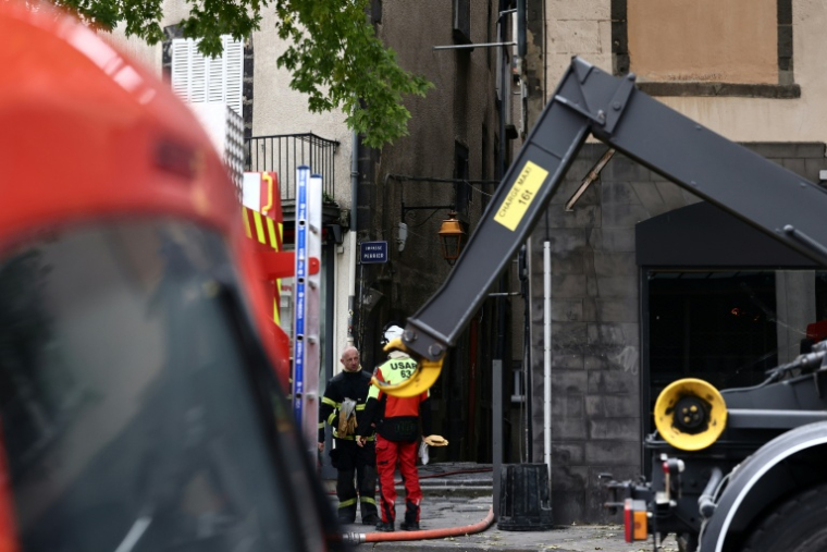 Des pompiers à proximité d'un immeuble ravagé par un incendie dans lequel trois corps ont été retrouvés, le 31 octobre 2026 à Clermont-Ferrand ( AFP / Alex MARTIN )