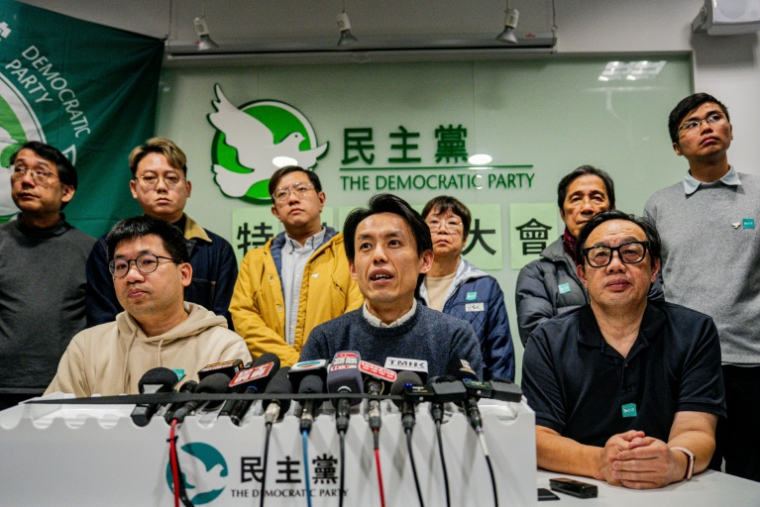 Lo Kin-hei (C), le dirigeant du Parti démocrate lors d’une conférence de presse, le 14 décembre 2025 à Hong Kong ( AFP / Leung Man Hei )