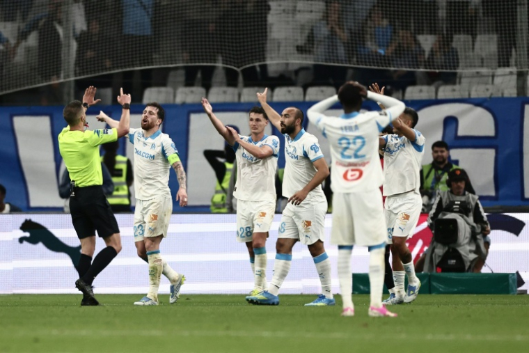 Les joueurs marseillais en discussion avec l'arbitre lors du match contre Nice, le 26 avril 2026 au Vélodrome ( AFP / Thibaud MORITZ )