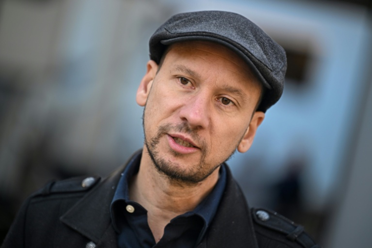 le producteur américano-hongrois Daniel Kresmery, de la société HeroSuared lors d'une interview avec l'AFP sur le plateau de tournage d'un film d'horreur dans un ancien hôpital psychiatrique de Budapest, le 7 novembre 2025 en Hongrie ( AFP / Attila KISBENEDEK )