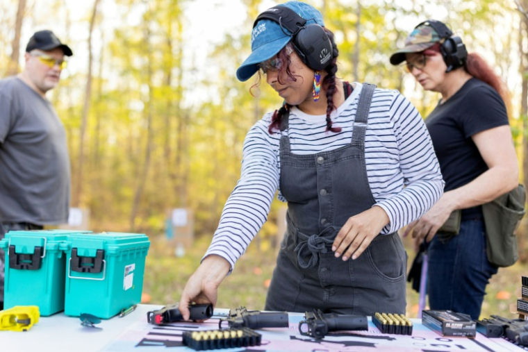 Akemi choisi un pistolet pendant un cours d'initiation au maniement des armes à feu, à Midlothian, en Virginie, le 11 avril 2026 ( AFP / Ryan M. Kelly )