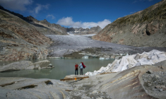 Des touristes devant le glacier du Rhône près de Gletsch, dans les Alpes suisses, le 12 septembre 2025 ( AFP / Fabrice COFFRINI )