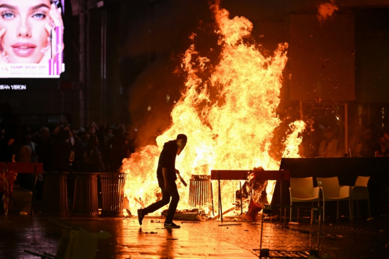 Des cartons et détritus incendiés lors d'une manifestation antigouvernementale à Milan, le 17 octobre 2026 en Italie ( AFP / Piero CRUCIATTI )
