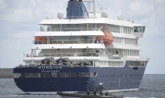 Un bateau de la Guardia Civil espagnole navigue à côté du bateau de croisière MV Hondius, touché par le hantavirus, dans le port de Granadilla de Abona, sur l'île de Tenerife, dans l'archipel espagnol des Canaries, le 11mai 2026 ( AFP / JORGE GUERRERO )
