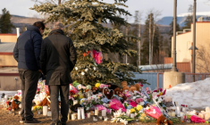 People bring flowers and pay their respects at a community vigil in Tumbler Ridge two days after the rural community experienced one of Canada’s deadliest shootings on February 12, 2026.  On February 10, an 18-year-old carried out a mass shooting in a remote mining town, killing six people at a local school, after slaying her mother and stepbrother. Canadian Police commander Dwayne McDonald said authorities still don't know the motive in Tuesday's mass shooting, but the shooter, who took her own life, was known to have mental health issues. ( AFP / Paige Taylor White )