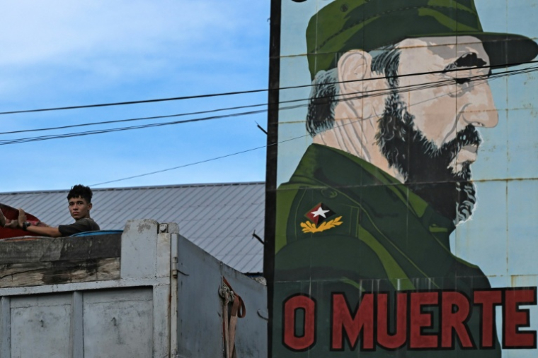Un jeune homme près d'un portrait de Fidel Castro, à La Havane, le 10 août 2026 ( AFP / YAMIL LAGE )