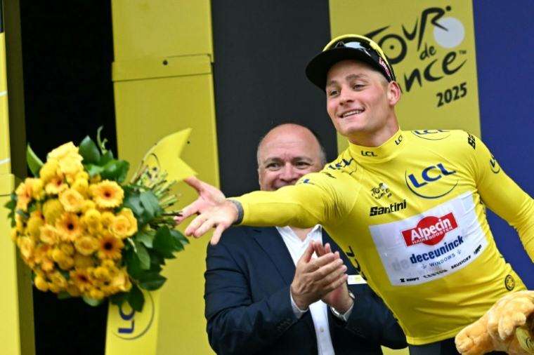 Mathieu van der Poel, maillot jaune sur le dos, jette son bouquet vers le public après sa victoire dans la 2e étape du Tour de France, le 6 juillet 2025 à Boulogne-sur-Mer ( AFP / Loic VENANCE )