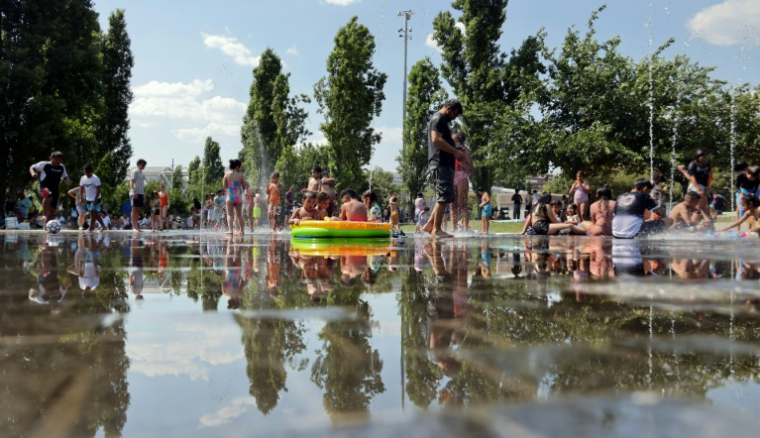 Des personnes tentent de se rafraîchir à Madrid, le 28 juin 2025, en pleine vague de chaleur ( AFP / Thomas COEX )