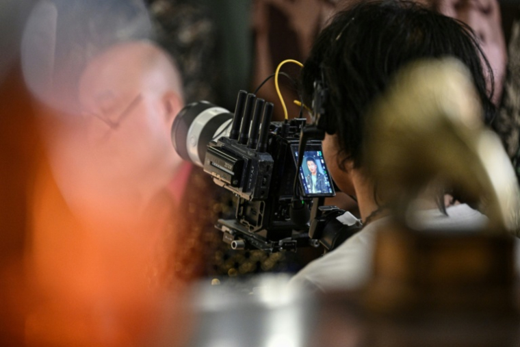 Une personne filme une scène dans un studio de mini-séries à Shanghai, le 10 octobre 2025 ( AFP / Jade GAO )