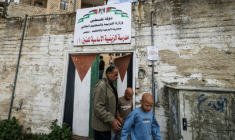 Les jumeaux Ahmad (d) et Mohammad, accompagnés par leur père Ibrahim al-Hajj, sortent de leur école à Naplouse, le 10 février 2026 en Cisjordanie occupée ( AFP / Jaafar ASHTIYEH )