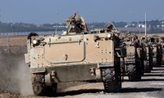 Un convoi de véhicules blindés de transport de troupes prend position près de la frontière entre Israël et la bande de Gaza