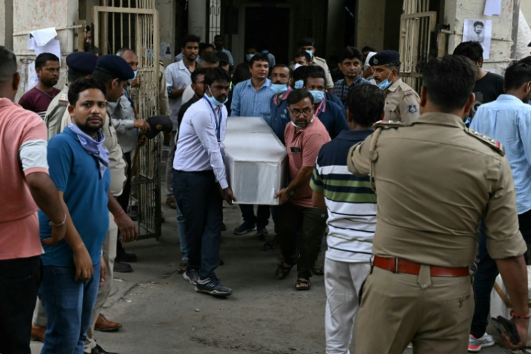 Un cercueil est sorti d'une salle d'autopsie d'un hôpital d'Ahmedabad, le 13 juin 2025, au lendemain du crash du vol 171 d'Air India dans un quartier résidentiel ( AFP / Punit PARANJPE )