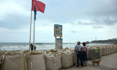 Un drapeau rouge interdisant la baignade sur la Grande plage de Biarritz, protégée par des sacs remplis de sable, le 26 août 2025, en prévision de la forte houle attendue  ( AFP / Gaizka IROZ )