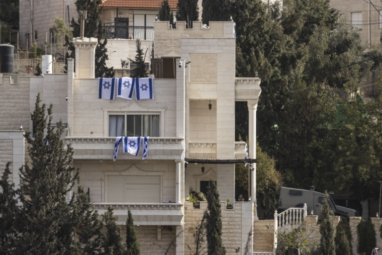 Des drapeaux israéliens sur une maison après que l'armée israélienne a forcé des Palestiniens à évacuer le quartier d'Ein Deir Baha, dans la ville occupée d'Hébron, en Cisjordanie, le 24 octobre 2026 ( AFP / JOHN WESSELS  )