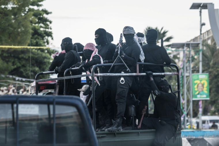 Des hommes armés masqués sans insigne visible circulent en camion à Stone Town au lendemain du scrutin présidentiel contesté en Tanzanie le 30 octobre 2025 ( AFP / MARCO LONGARI )