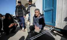 Wounded Palestinians arrive at Al-Ahli al-Arabi hospital, in Gaza City