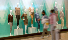 Shoppers walk past a window display of mannequins at the Christiana Mall in Newark
