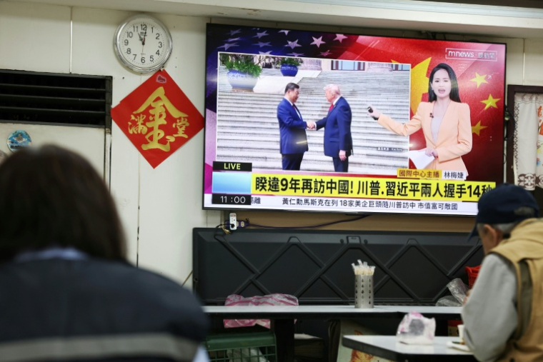Une télévision diffuse un reportage dans un restaurant de Taipei, le 14 mai 2026, à Taïwan, montrant la rencontre entre le président américain Donald Trump et le président chinois Xi Jinping à Pékin ( AFP / I-Hwa Cheng )