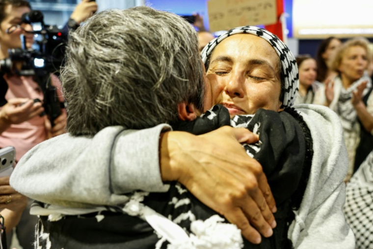 Une militante française, détenue et expulsée par Israël après l'interception de la flottille pour Gaza, embrasse une proche à son arrivée à l'aéroport Roissy-Charles-de-Gaulle, le 22 mai 2026, au nord de Paris ( AFP / SIMON WOHLFAHRT )