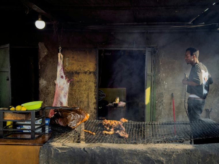 The shanty town has its own butcher. ( AFP / Tiziana FABI )