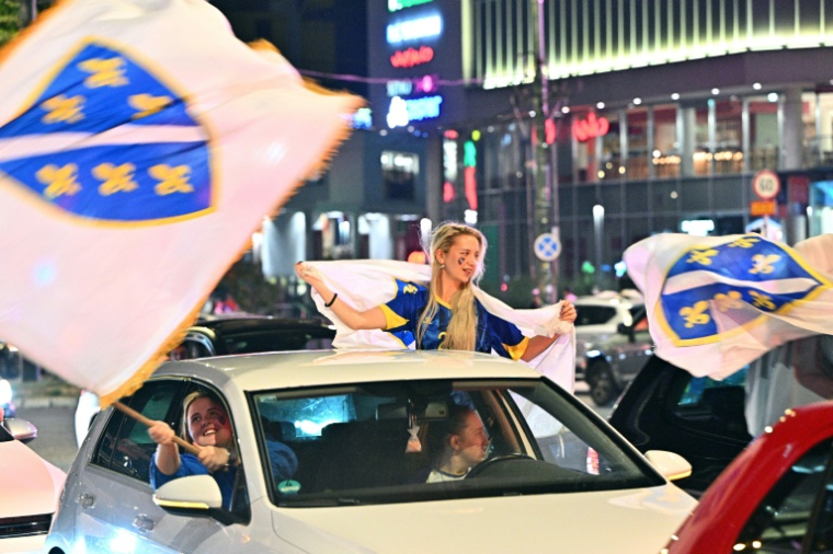 Les supporters de la Bosnie-Herzégovine fêtent la qualification de leur pays pour les 16es de finale du Mondial-2026, à Sarajevo, le 24 juin 2026 ( AFP / ELVIS BARUKCIC )