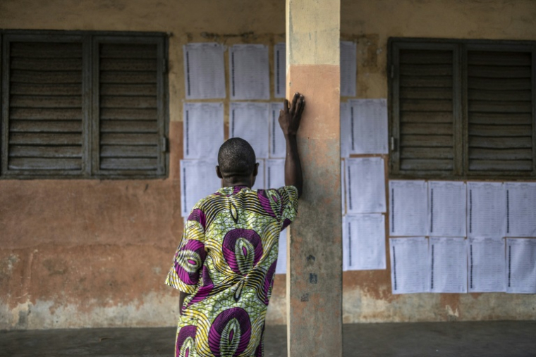 Un électeur cherche son nom sur la liste électorale affichée dans une école primaire servant de bureau de vote pour l'élection présidentielle au Bénin, à Cotonou, le 12 avril 2026 ( AFP / OLYMPIA DE MAISMONT )
