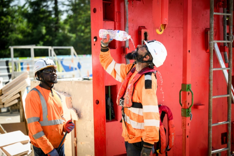 Un travailleur du bâtiment se rafraîchit, à Nantes le 19 juin 2025, lors de la vague de chaleur qui touche la France ( AFP / Loic VENANCE )