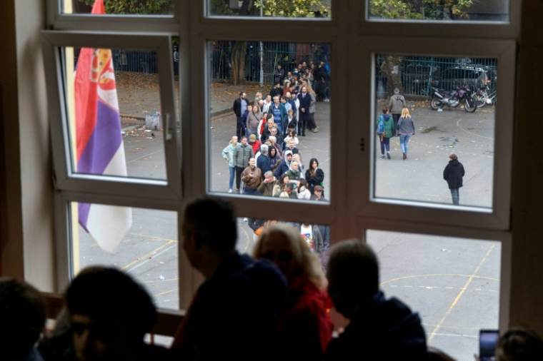 Les électeurs patientent à l'entrée d'un bureau de vote à Belgrade, lors des législatives, le 25 octobre 2026. ( AFP / Milos Milanovic )