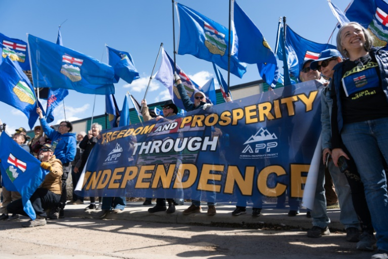 Des militants séparatistes de l'Alberta rassemblés devant les locaux d'Elections Canada pour déposer une pétition demandant la sécession de cette province, le 4 mai 2026 à  Edmonton (Canada). ( AFP / Henry MARKEN )