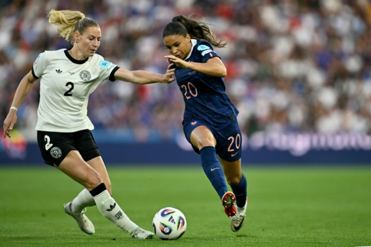 L'attaquante française Delphine Cascarino (d) à la lutte avec la défenseuse allemande Sarai Linder, en quart de finale de l'Euro, le 19 juillet 2025 à Bâle ( AFP / Fabrice COFFRINI )