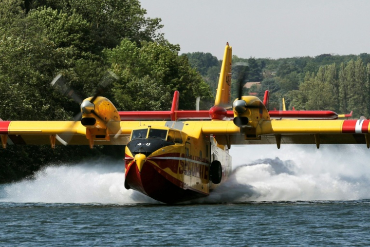 Un Canadair CL-415 de la Sécurité civile effectue des manœuvres d'écopage au-dessus de la Seine à Chartrettes, le 13 juillet 2026, pour lutter contre un incendie dans la forêt de Fontainebleau, en Seine-et-Marne ( AFP / Thomas SAMSON )