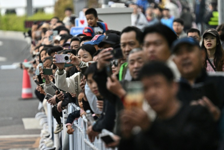People gather to watch the second Beijing E-Town Half Marathon and Humanoid Half Marathon in Beijing on April 19, 2026. ( AFP / Pedro PARDO )