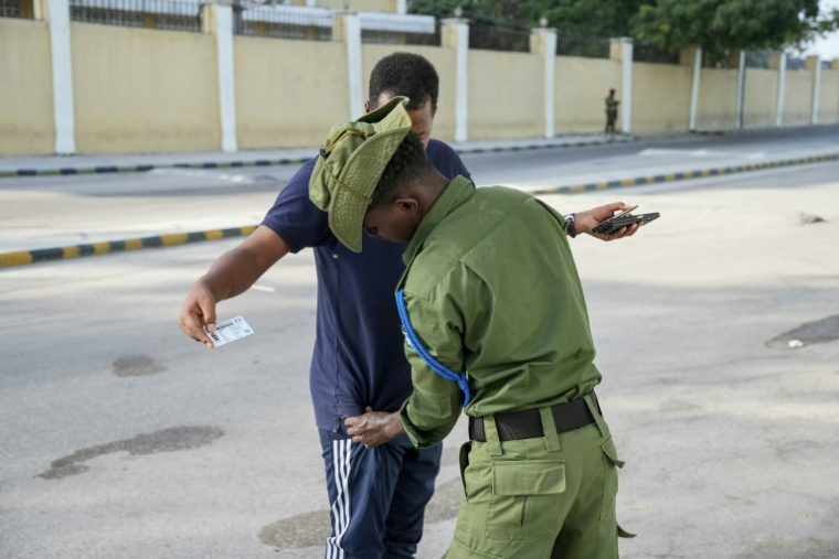 Un membre des forces de sécurité somaliennes fouille un électeur pour les élections locales de Mogadiscio le 25 décembre 2025 ( AFP / Hassan Ali ELMI )