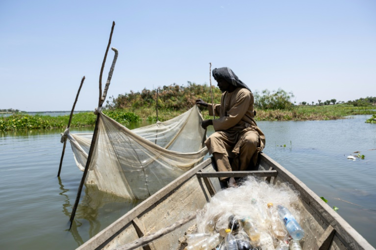 Ahmat Moussa, 42 ans, réfugié dans le camp de personnes déplacées à Yakoua, dans la province du lac Tchad, au Tchad, vérifie un filet le 21 juin 2025 ( AFP / Joris Bolomey )