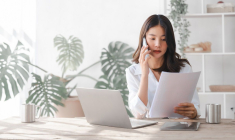 Une femme en train de passer un appel téléphonique pour la gestion de son épargne (Crédits: Adobe Stock)