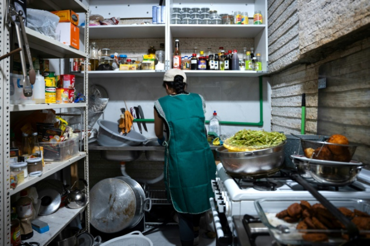 Une femme travaille dans la cuisine de Tres Marias, une organisation caritative venant en aide aux travailleurs migrants à Beyrouth, le 16 mai 2026 au Liban ( AFP / Chantale SALAMEH )