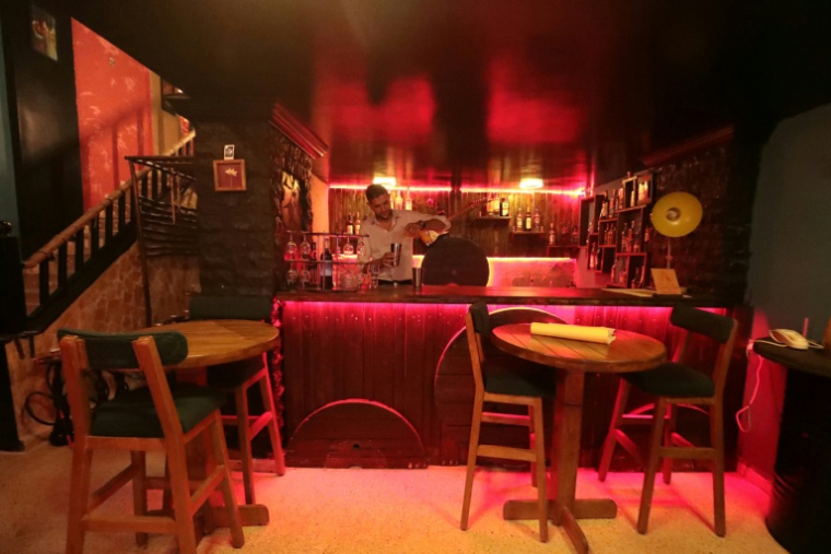 Un barman prépare des cocktails alcoolisées dans un bar de Qamichli, dans le nord-est de la Syrie, le 18 août 2026 ( AFP / Delil SOULEIMAN )
